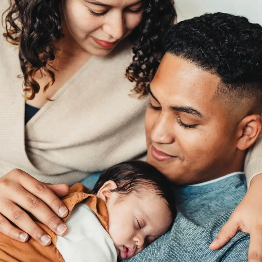 A couple holding their new baby