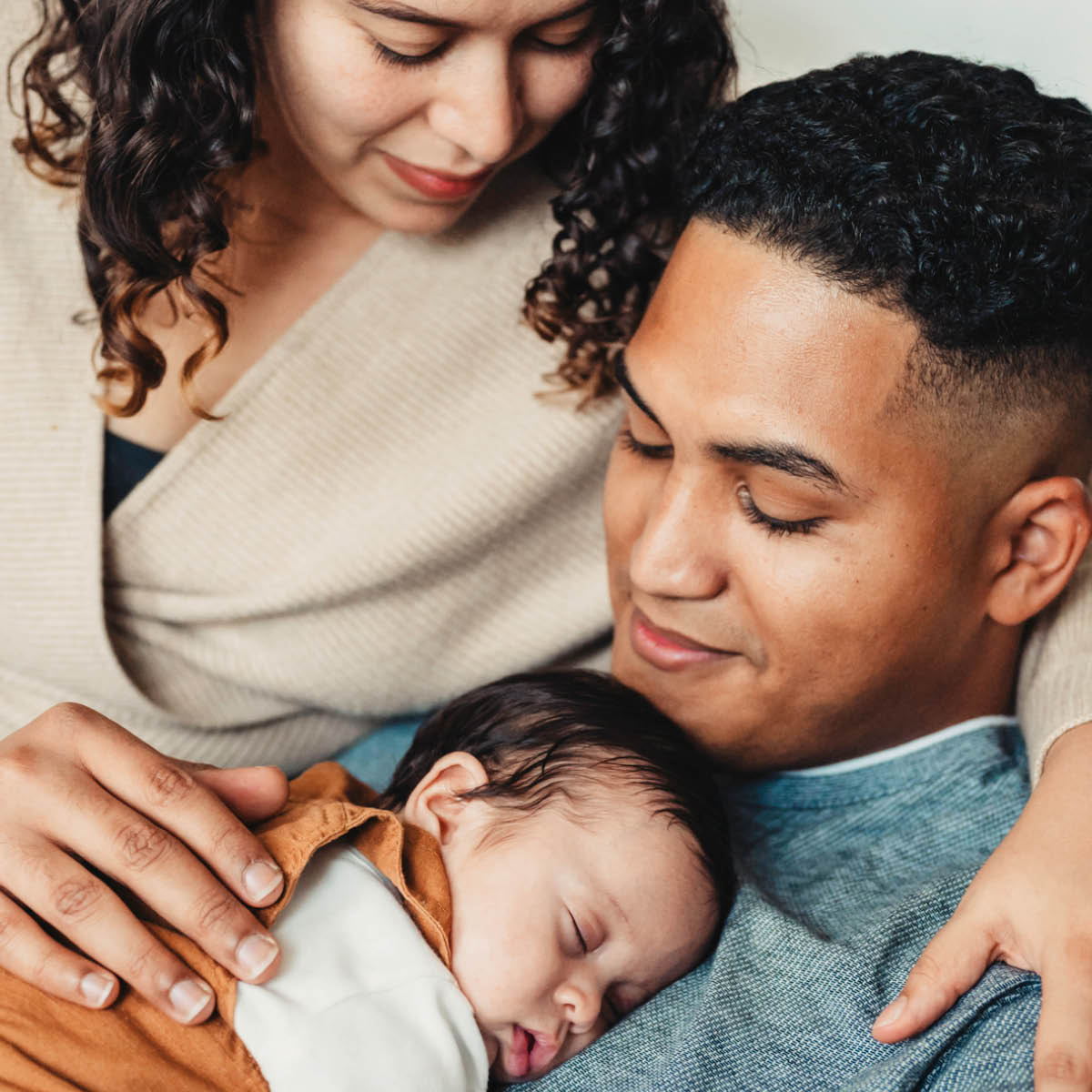 A couple holding their new baby